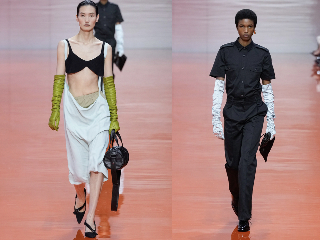 Modella in total look Prada SS26 con uniforme grigia e dettagli futuristi